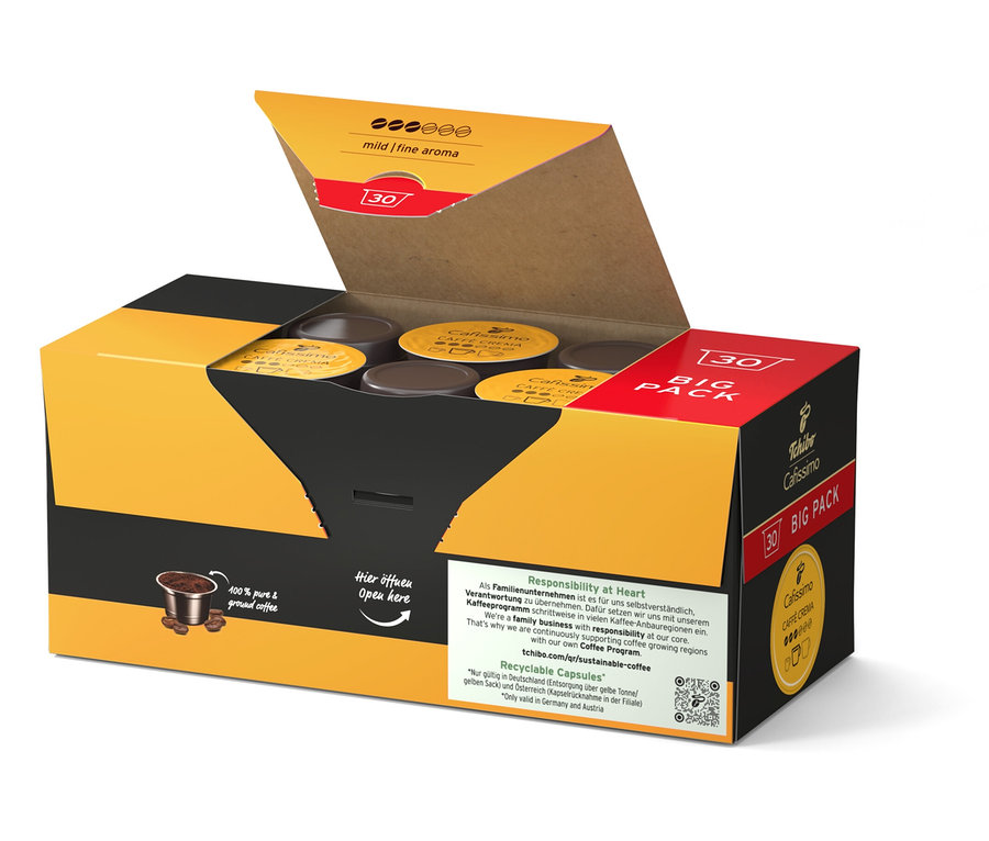 Otvorená žlto-čierna krabica s kávovými kapsulami.