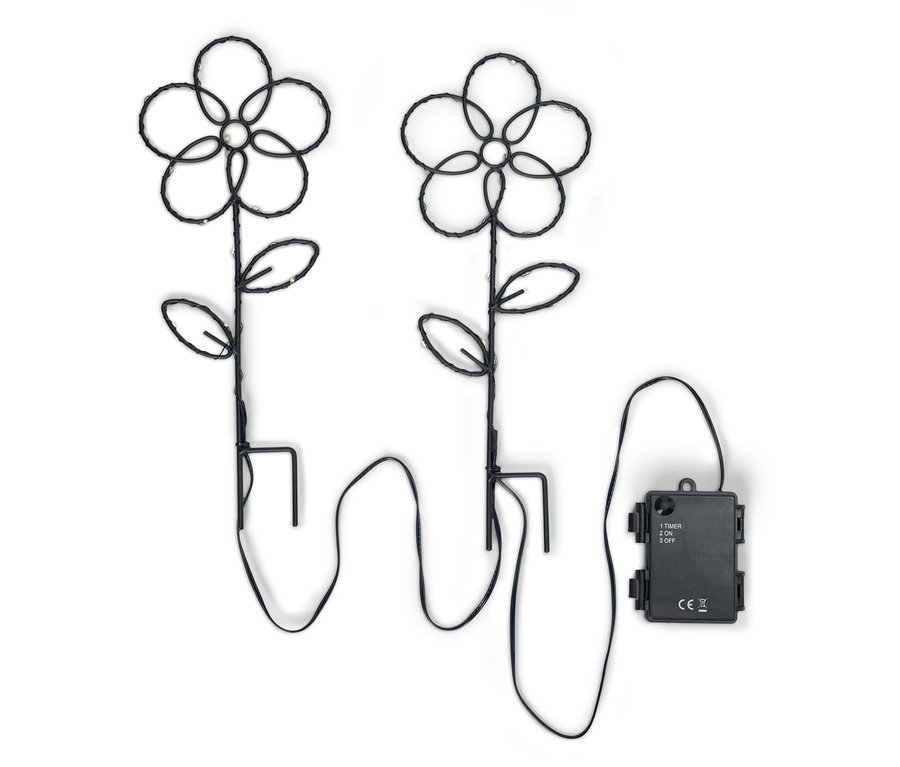 Dve čierne kvetinové záhradné svetlá s LED svetlami a batériovým boxom na bielom pozadí.