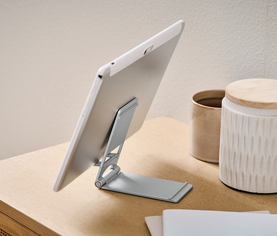 Tablet je umiestnený na stojane na smartfón a tablet.