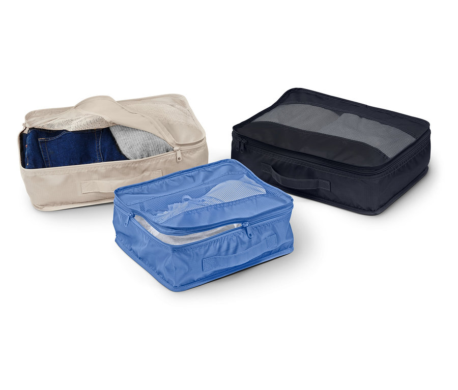 Tri látkové úložné boxy v béžovej, modrej a čiernej farbe ležia na bielom pozadí.