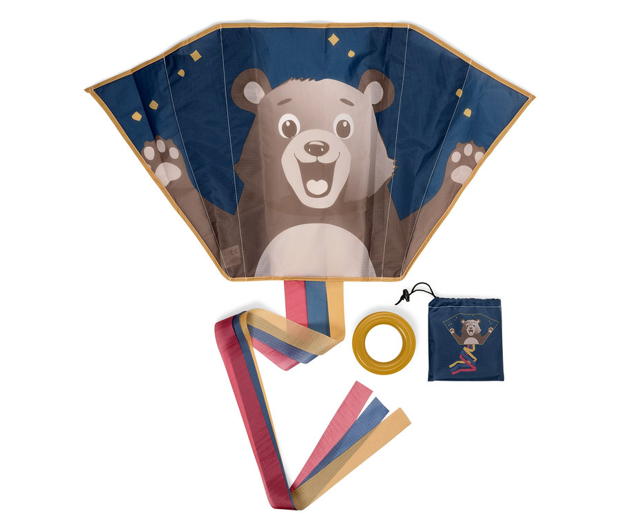 Modrý drak s medveďom, žltý kruh a modrý obal s rovnakou potlačou na bielom pozadí.