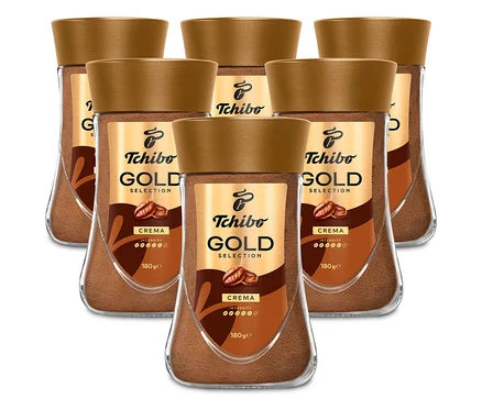 Šesť pohárov instantnej kávy Tchibo Gold Selection Crema je usporiadaných v dvoch radoch.