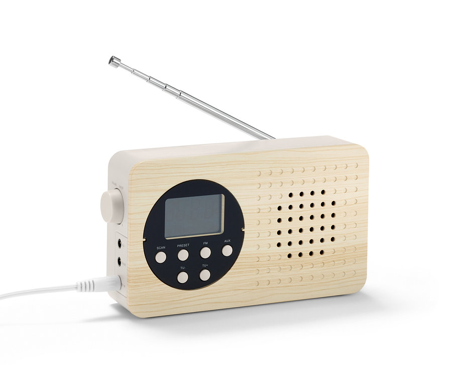 Detailný záber na kompaktné FM rádio s dreveným puzdrom a vysunutou anténou.