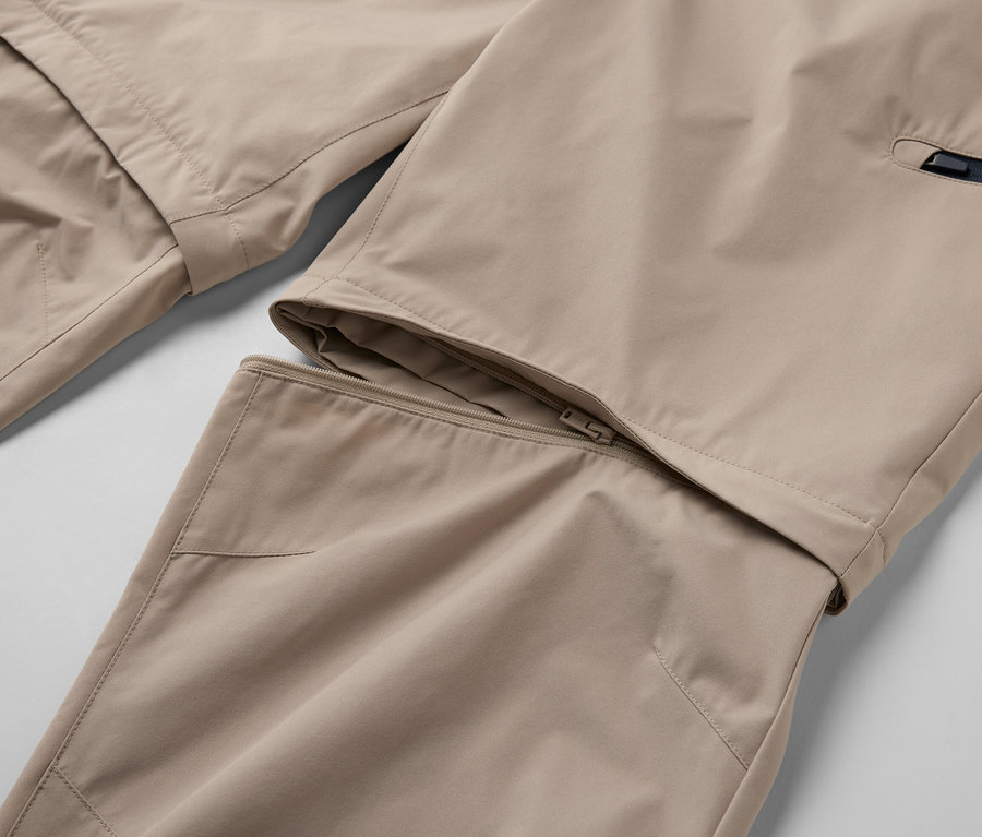 Detail béžových funkčných nohavíc 2 v 1 so zipsom.