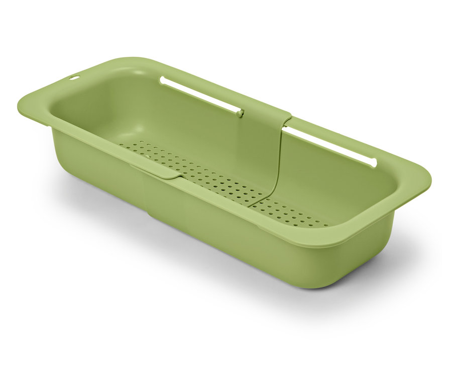 Zelené rozšíriteľné sitko do drezu na bielom pozadí.