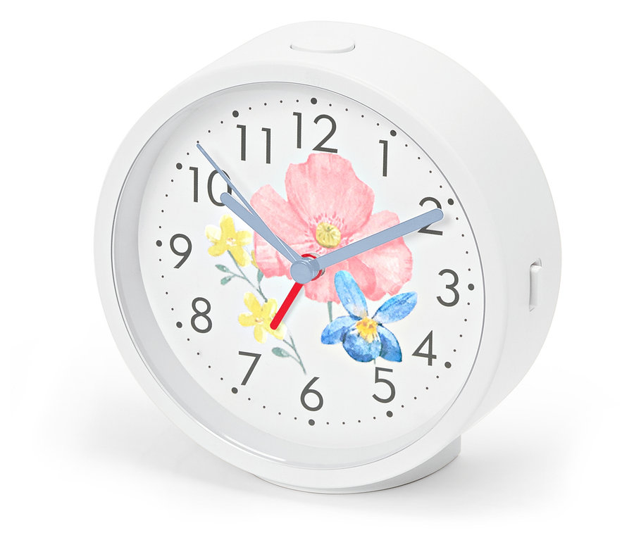 Budík s podsvietením, ciferník s kvetinovým vzorom.