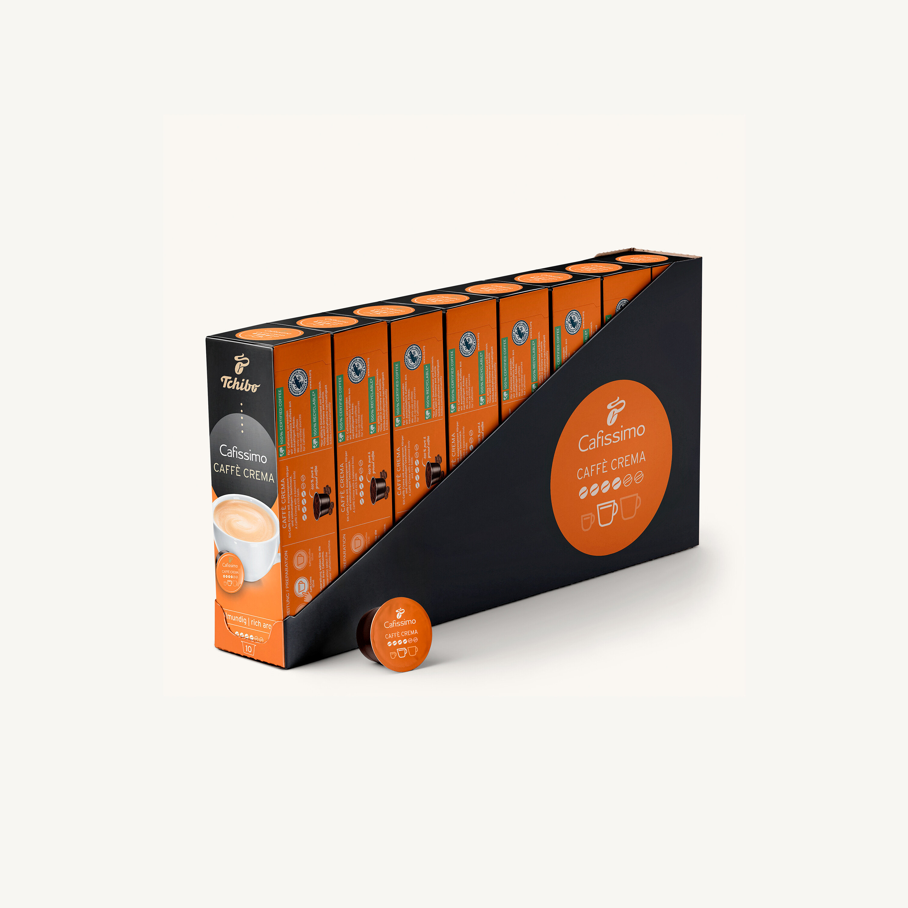 Balení kávových kapslí Tchibo Cafissimo Caffe Crema v černém držáku.