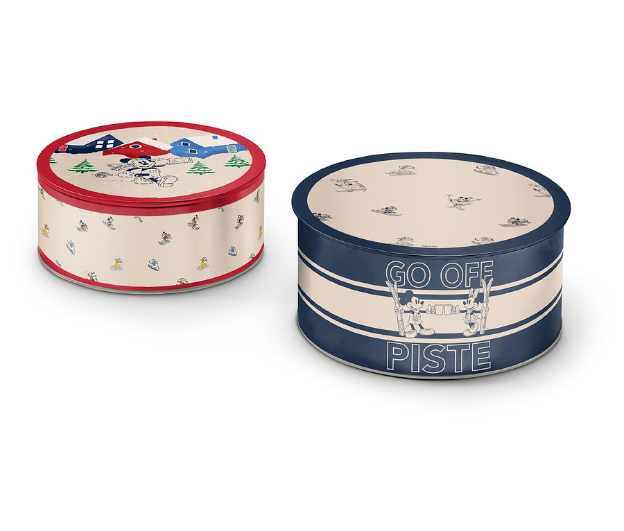 Dve okrúhle plechové dózy s rôznymi vzormi a farbami.