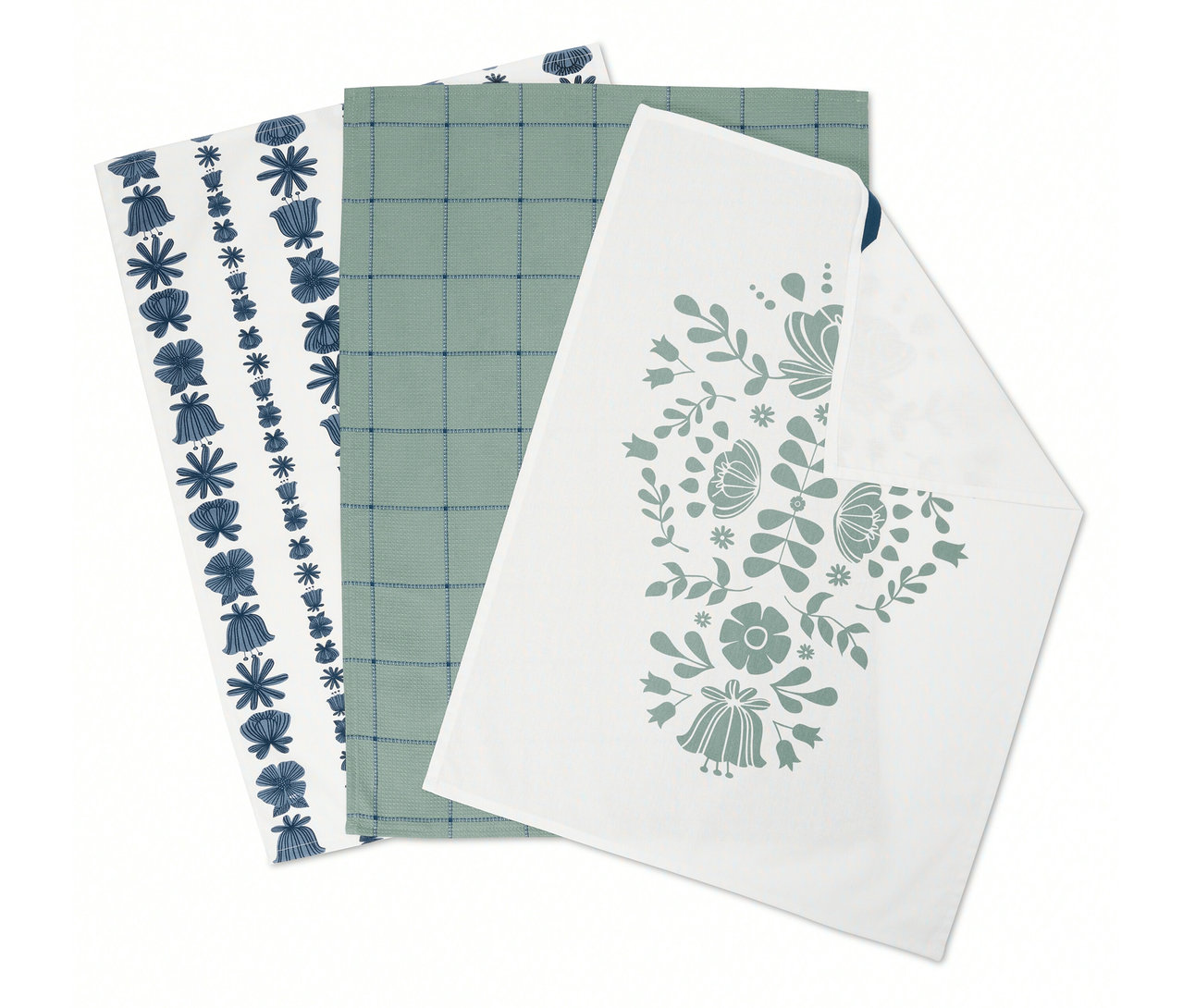 Tri zložené utierky: jedna s modrými kvetmi, jedna so zelenou mriežkou a jedna s kvetinovým vzorom.