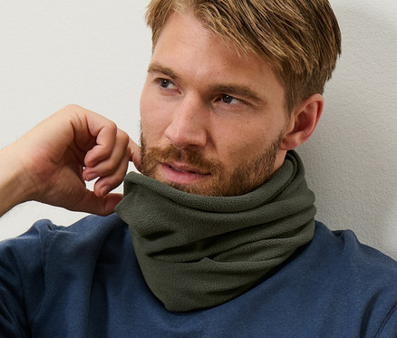 Muž s hnedými vlasmi a bradou má na sebe modrú mikinu a khaki flísový termogolier.