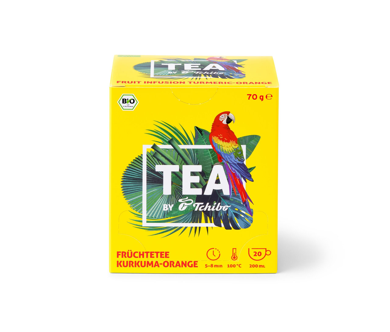 Žltá krabička čaju TEA by Tchibo BIO s príchuťou kurkumy a pomaranča s obrázkom papagája a tropických listov.
