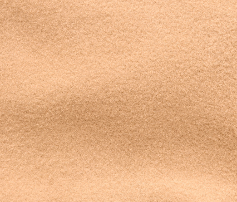 Detailný záber na textúru béžovej látky.