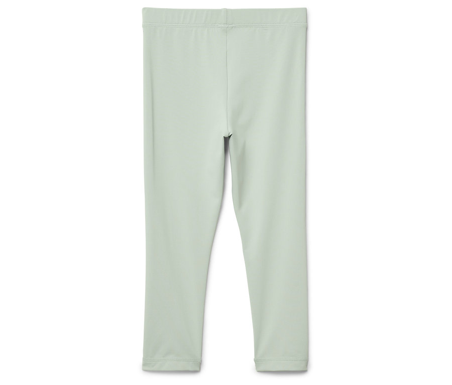 Svetlozelené legíny na bielom pozadí.