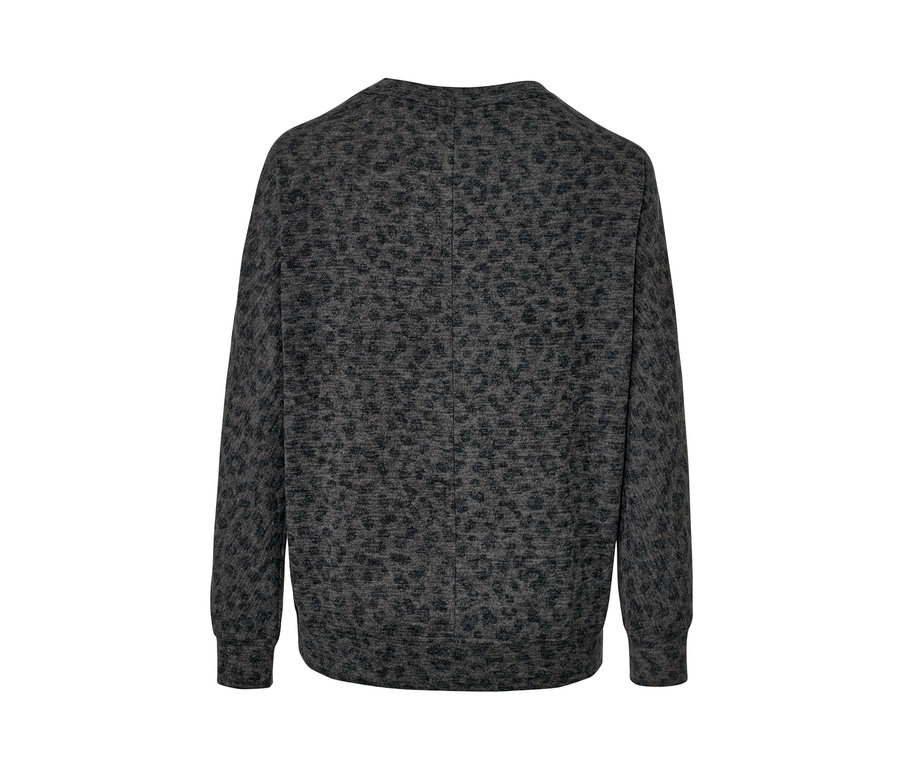 Detail šedého trička s netopierími rukávmi s potlačou zozadu.