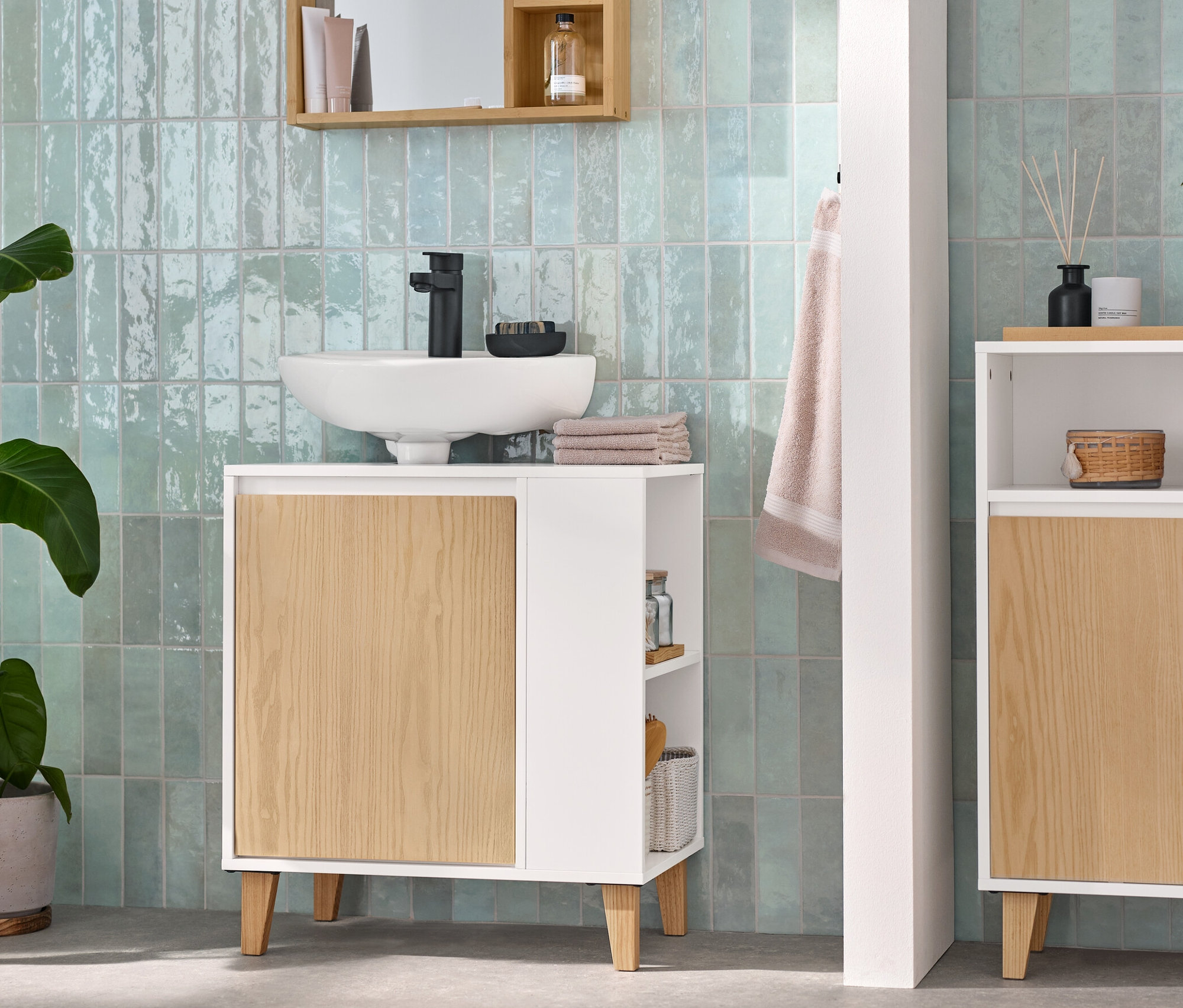 Kúpeľňa s umývadlovou skrinkou s dvierkami a poličkou naboku, odkladacia skrinka s 2 dvierkami a otvoreným priečinkom a zrkadlom s odkladacími poličkami.