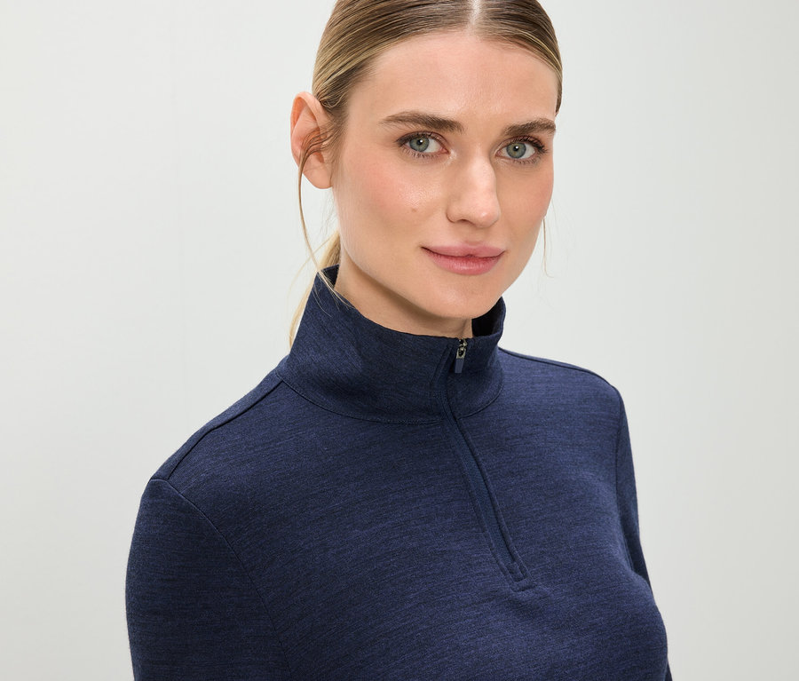 Portrét blondíny v modrej mikine na zips.
