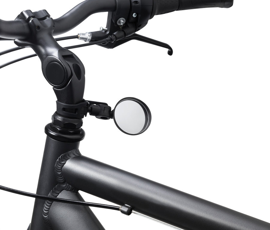 Detail bicykla s čiernymi riadidlami a malým zrkadlom na bicykel.