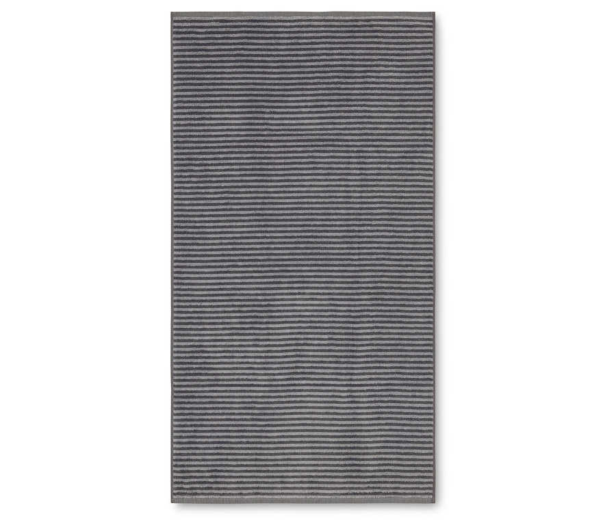 Obdĺžnikový koberec s horizontálnymi pruhmi v odtieňoch sivej a striebornej leží na bielom pozadí.