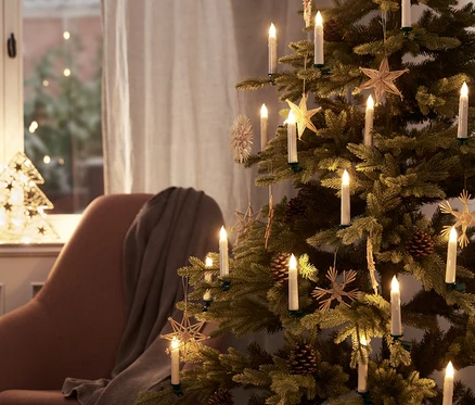 Vianočný stromček je ozdobený 30 LED sviečkami a ozdobami.