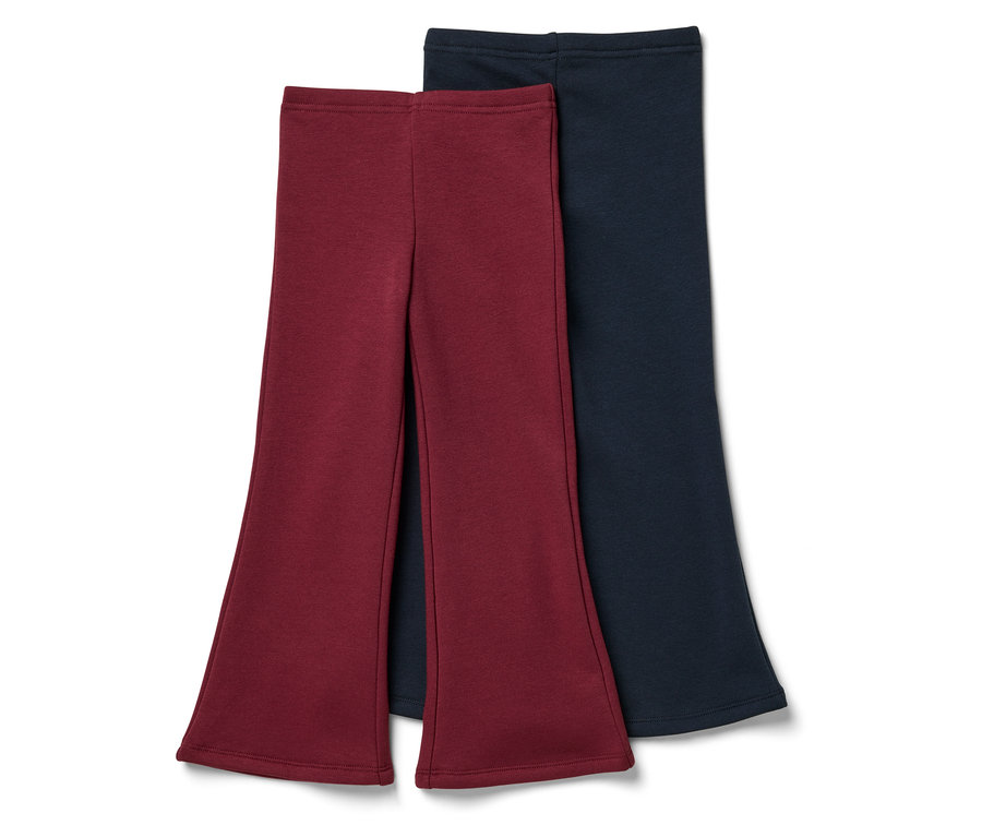 Dvoje nohavice do zvonu: jedny vínové a jedny tmavomodré.