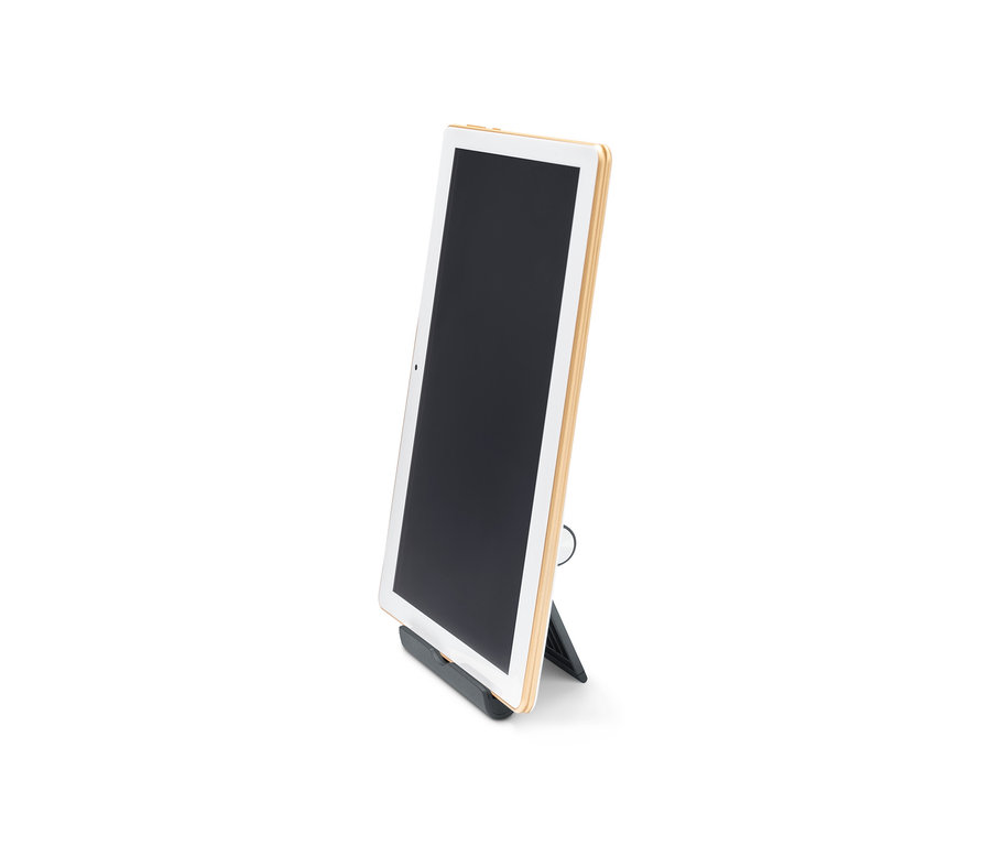 Tablet je umiestnený v čiernom stojane na smartfón a tablet.