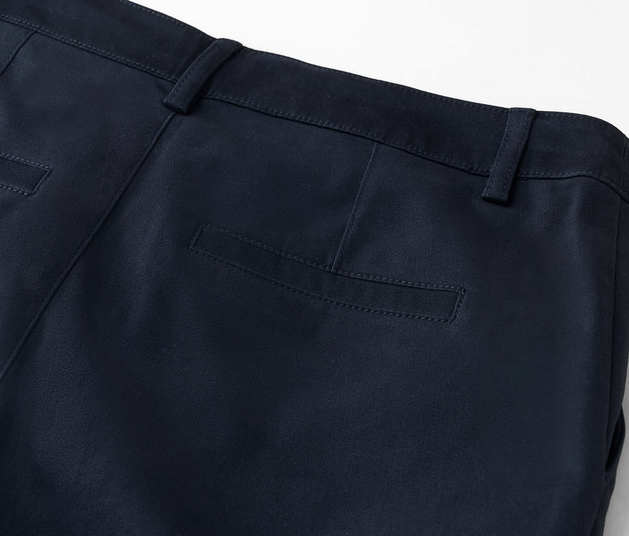 Detailný pohľad na zadnú časť tmavomodrých nohavíc so zadným vreckom.