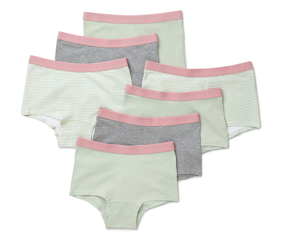 Sedem mätových dievčenských nohavičiek leží na sebe.