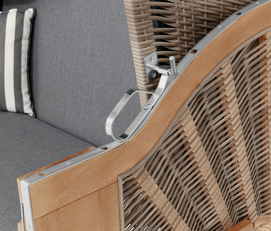 Detail plážového koša s opierkou na ruky, sivým vankúšom a pruhovaným vankúšom.