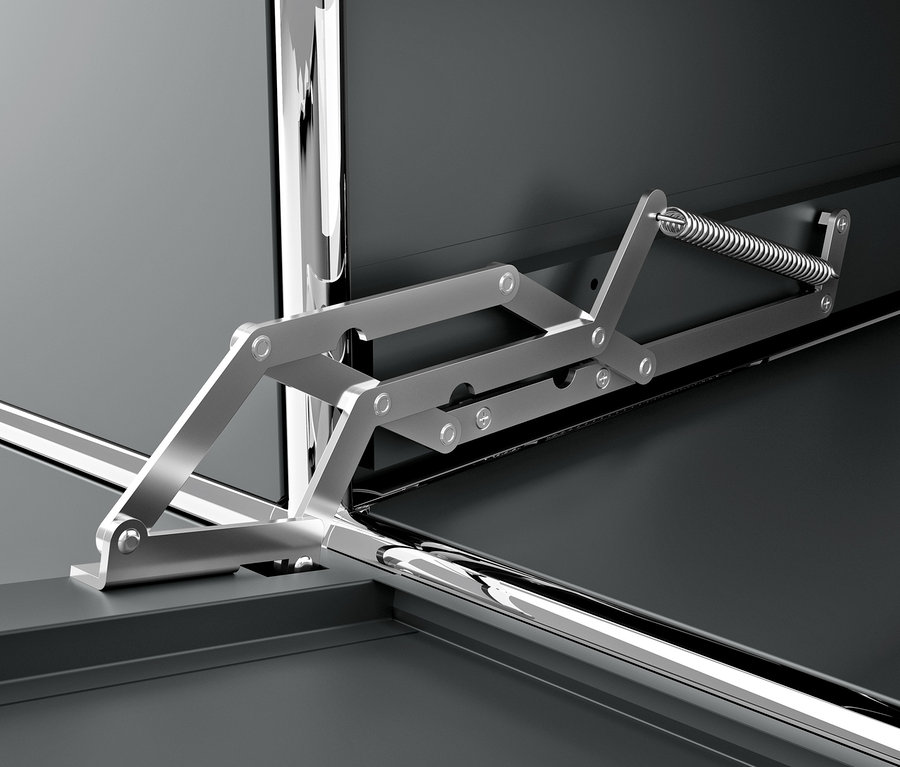 Detail šedej kovovej skrinky CN3 s výklopnou priehradkou a mechanizmom.