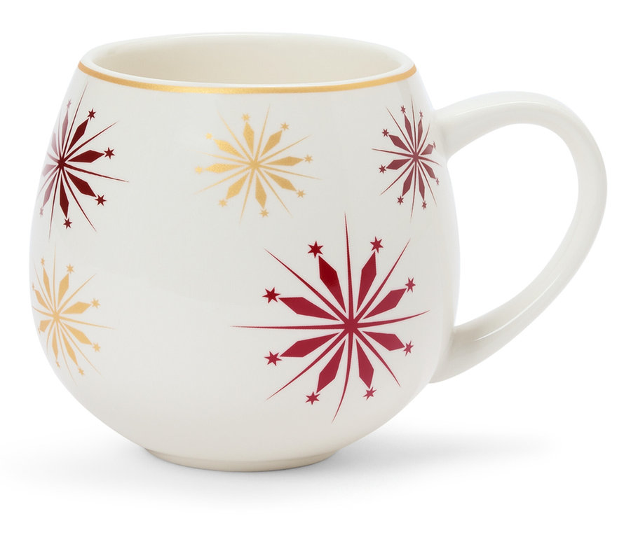 Biely hrnček s červenými a zlatými vločkami.