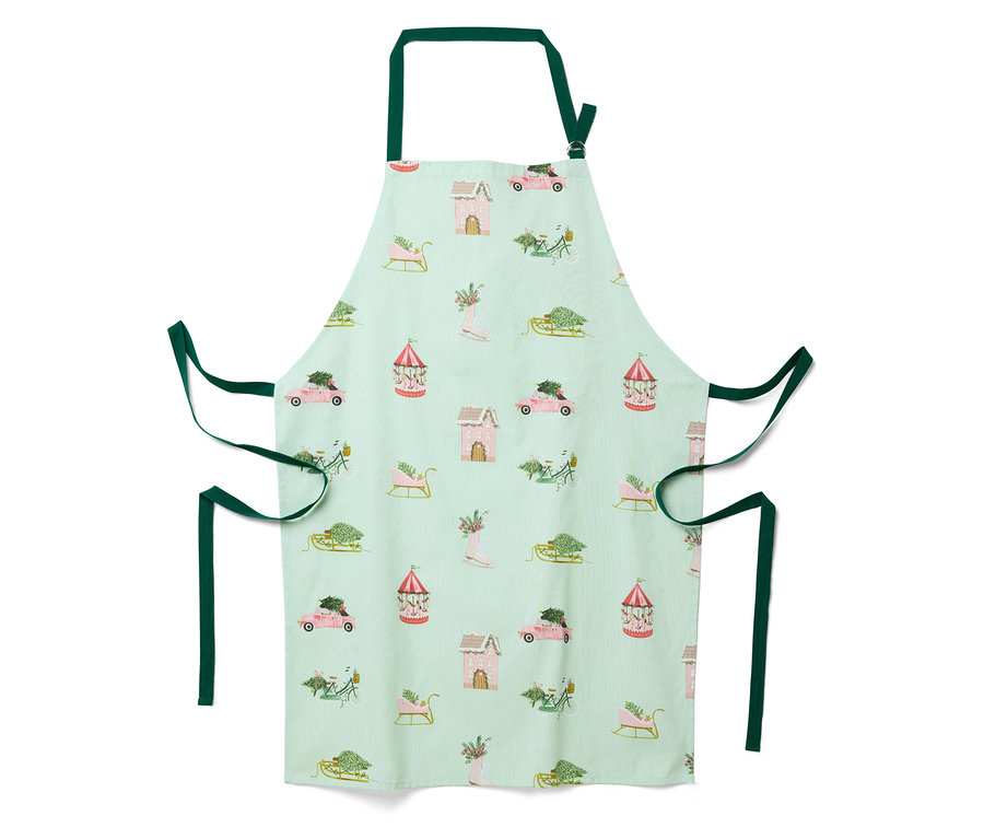 Svetlozelená zástera s vianočným motívom domčekov, áut, saní a kolotočov.