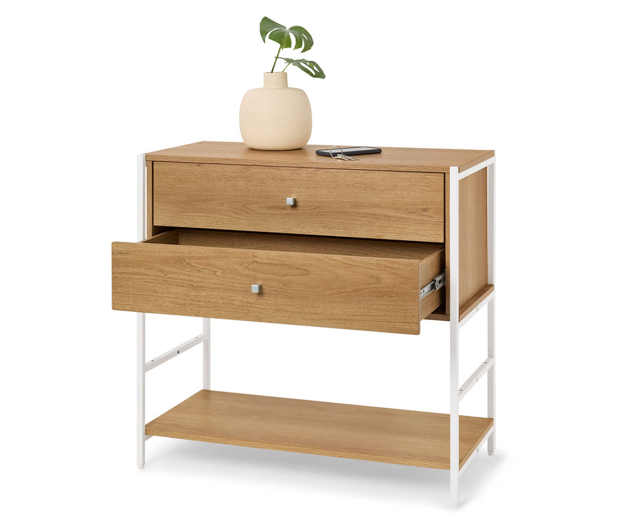 Komoda zo svetlého dreva s dvoma zásuvkami, z ktorých jedna je otvorená, a bielym kovovým rámom. Hore stojí váza so zelenou rastlinou.