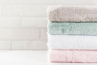Nenahraditeľný kúpeľňový textil: Nastohované, čisté a pestré uteráky z bavlneného froté.